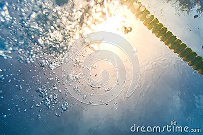 Danger of Drowning Concept with Air Bubbles and rays of Sun Light Stock Photo