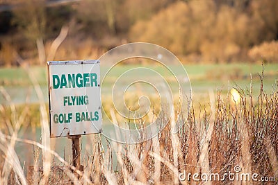 Danger flying balls a funny golf sign near golf course Stock Photo