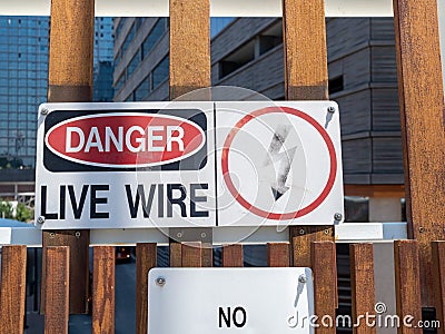 Danger live wire power lightning bolt warning sign posted near hazard Stock Photo