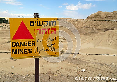 `Danger! Mines!` sign in Hebrew, English and Arabic languages Stock Photo