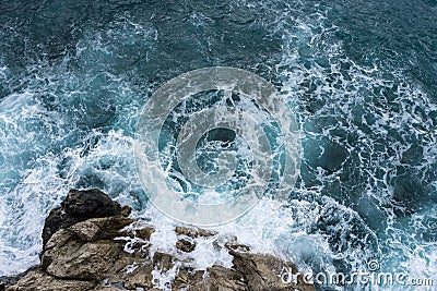 Danger sea wave crashing on rock coast with spray and foam before storm in Autum Positano, Italy Stock Photo