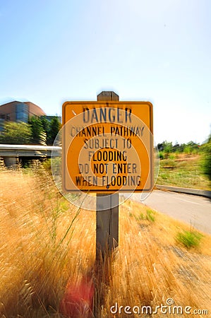 Danger sign on a gold dry grass Zoom Burst Photography Stock Photo