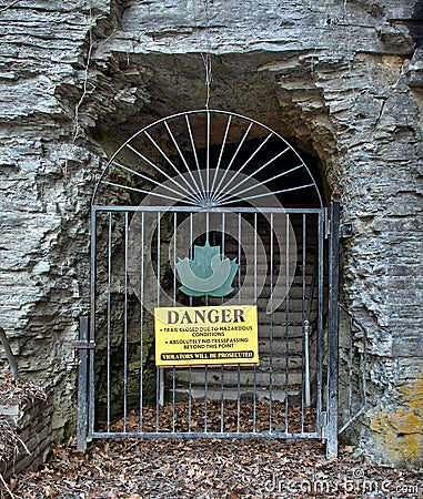 Danger sign and iron gate blocking nature trail Stock Photo