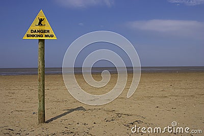 Danger sinking mud sign, sand point beach England uk Stock Photo