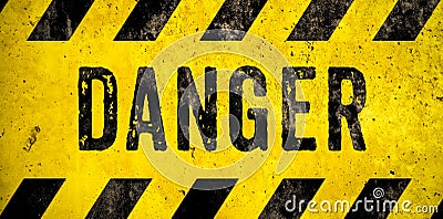 DANGER warning sign word text as stencil with yellow and black stripes painted over concrete wall danger background Stock Photo