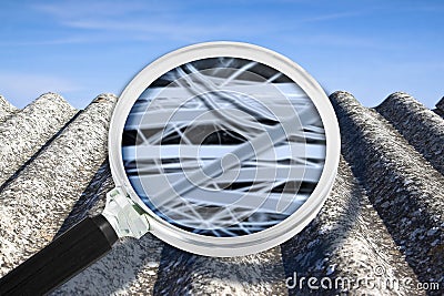 Dangerous asbestos roof with airborne fibers seen through a magnifying glass Stock Photo