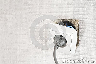 Dangerous bad,broken socket,plug in bathroom,falling out of wall. Outlet installation in old apartment. Poor electrical Stock Photo