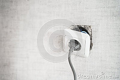 Dangerous bad,broken socket,plug in bathroom,falling out of wall. Outlet installation in old apartment. Poor electrical Stock Photo