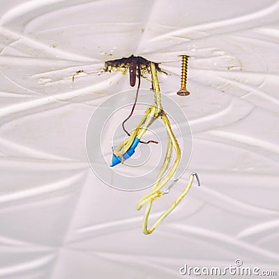 Dangerous bad wiring which hangs on ceiling Stock Photo