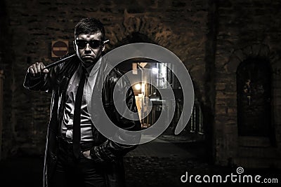 Dangerous criminal man on the street at night Stock Photo