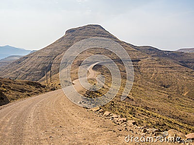 Dangerous and curvy mountain dirt road with steep drop to the valley, Lesotho, Southern Africa Stock Photo