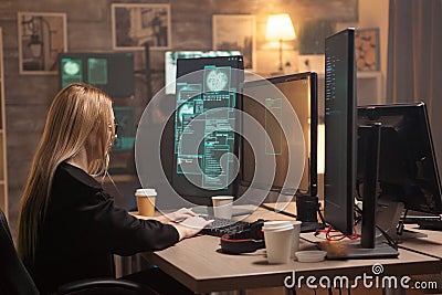 Dangerous female hacker writing a virus on computer Stock Photo