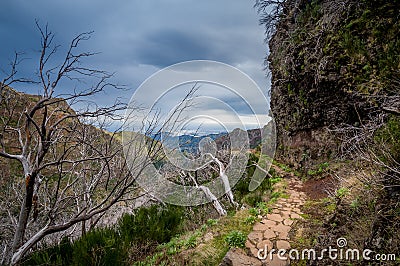 Dangerous hiking path at the mountains of Madeira island. Stock Photo