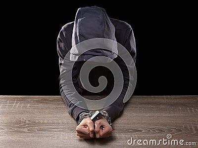 Dangerous Hooded Hacker Breaks into Government Data Servers and Infects Their System with Virus.. Arrested in handcuffs, a chain a Stock Photo