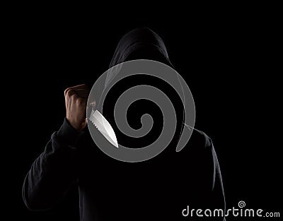 Dangerous hooded man holding knife Stock Photo