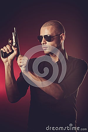Dangerous man with a gun Stock Photo