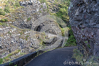 Dangerous part of the old road with rockfall Stock Photo