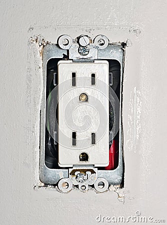 Dangerous power outlet with exposed wires without the plastic wall plate safety cover. Stock Photo