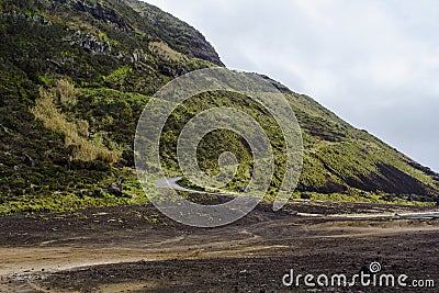 Dangerous road on hill with many curves and inclination in volcanic area Stock Photo