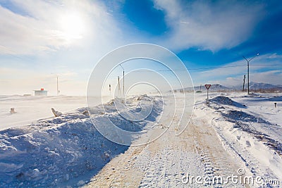 Dangerous snowing road with road signs for driving cars and public transport during blizzard Stock Photo