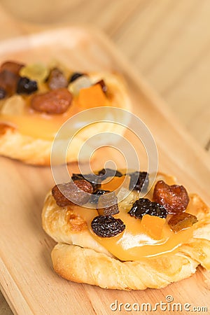 Danish custard with mixed dried fruit on wooden dish Stock Photo