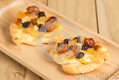 Danish custard with mixed dried fruit on wooden dish Stock Photo