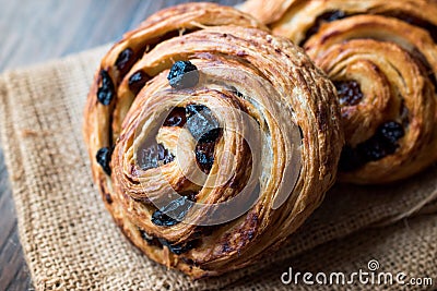 Danish Spiral Cinnamon Raisin Roll / German Pastry Schnecken on Sack. Stock Photo