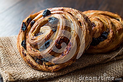 Danish Spiral Cinnamon Raisin Roll / German Pastry Schnecken on Sack. Stock Photo