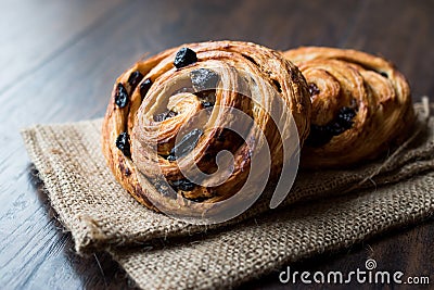 Danish Spiral Cinnamon Raisin Roll / German Pastry Schnecken on Sack. Stock Photo