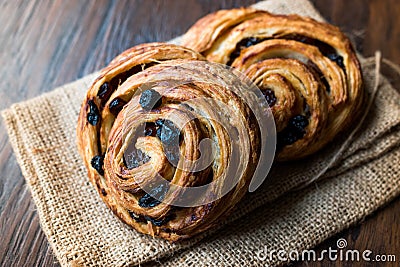 Danish Spiral Cinnamon Raisin Roll / German Pastry Schnecken on Sack. Stock Photo