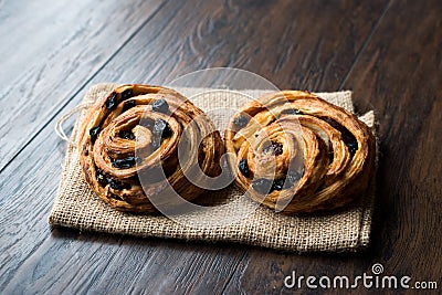 Danish Spiral Cinnamon Raisin Roll / German Pastry Schnecken on Sack. Stock Photo
