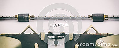 DANKE word in capital letters on a typewriter sheet Stock Photo