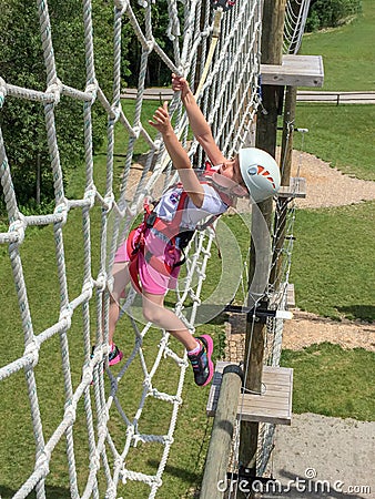 Daring Young Girl on Obstacle Course Stock Photo