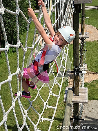 Daring Young Girl on Obstacle Course Stock Photo