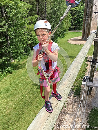 Daring Young Girl on Obstacle Course Stock Photo