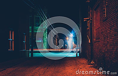 Dark alley and light trails in Hanover, Pennsylvania at night. Stock Photo