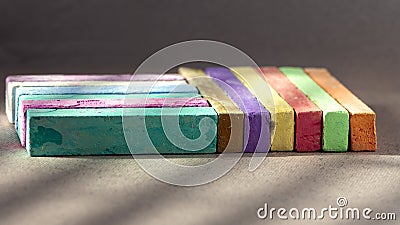 On a dark background, bright, colored crayons.Rainbow colorful chalk pastel for preschool children. Stock Photo