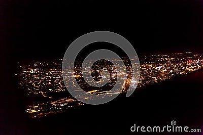 Dark background view of city with lights from aeroplane. Night lights in the city. Aeroplane view of dark nigh above the Stock Photo