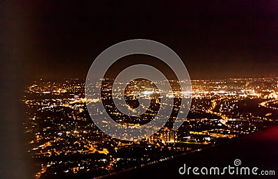 Dark background view of city with lights from aeroplane. Night lights in the city. Aeroplane view of dark nigh above the Stock Photo