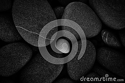 Dark black abstract smooth round pebbles texture background Stock Photo