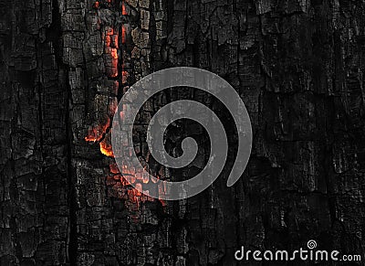 Dark black background of burnt wood with red hot embers still burning Stock Photo