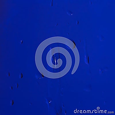 Dark blue background with a drop of liquid Stock Photo