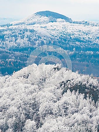 Dark blue forest hills covered with hoarfrost. Early winter freeze weather Stock Photo