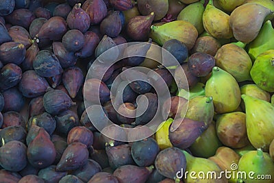 Dark blue and green figs in the market as a background Stock Photo