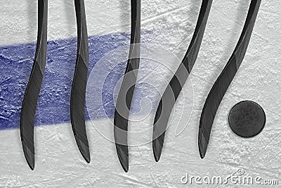 The dark blue line, hockey sticks and puck Stock Photo
