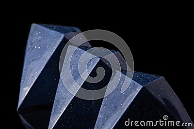 Dark blue luxury handmade chocolate candies on black background. Product concept for chocolatier Stock Photo