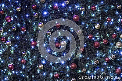 Dark blue toning Christmas tree toy and garland background festive view Stock Photo