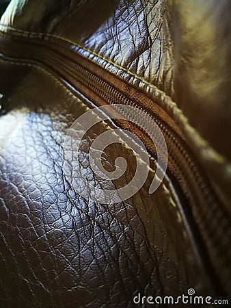 Dark brown background pattern Leather bag mouth with zipper closure. Stitches between the zipper and leather bag Stock Photo