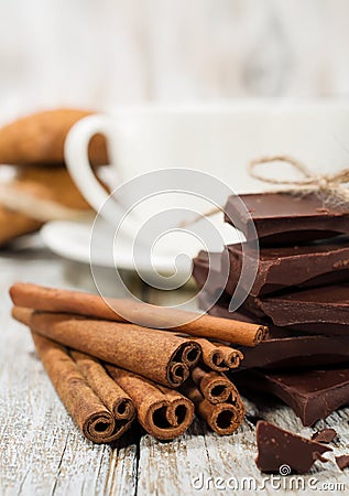 Dark chocolate , cinnamon sticks and a cup of coffee Stock Photo