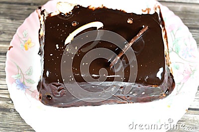 Dark chocolate and pieces of chocolate from a birthday cake of three different pieces spongy creamy cake for celebrations, Stock Photo